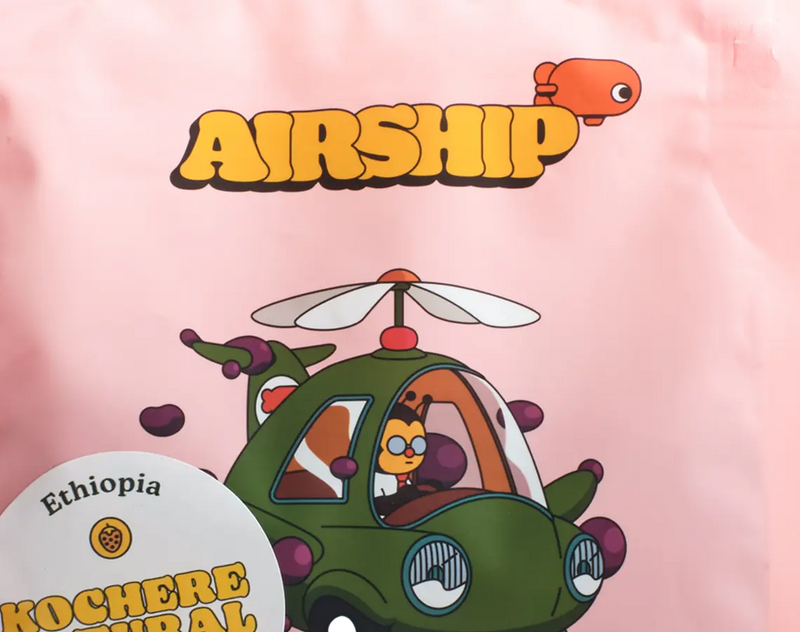 Cartoon airship with 'Airship' text and Ethiopia coffee label on a pink background