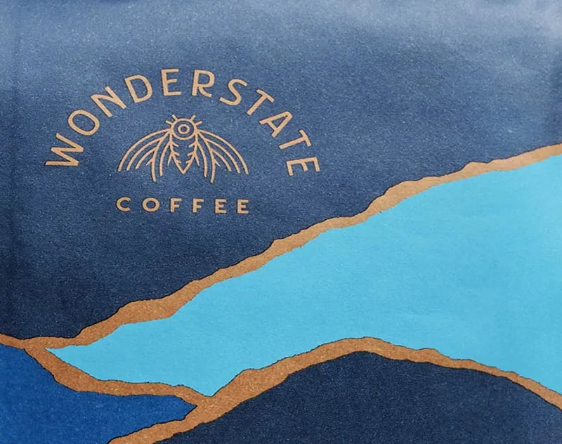 Wonderstate Coffee logo on a blue and brown landscape design